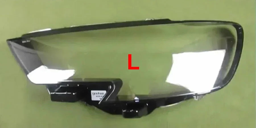 Motorcycle windshield with 'L' marking on a green background