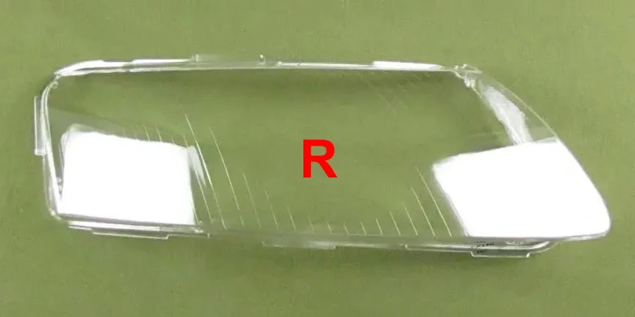 Clear car headlight cover with 'R' marking on a green background