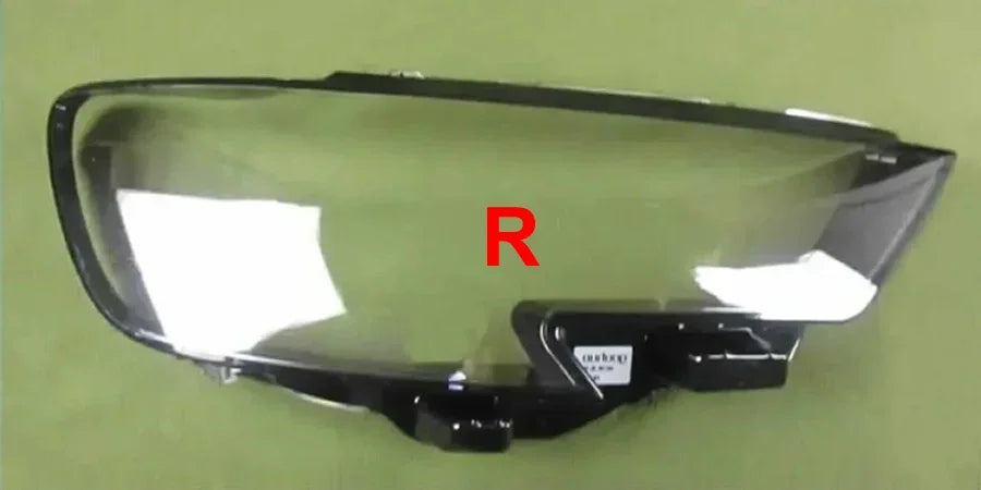 Car headlight assembly with 'R' marking on a green background