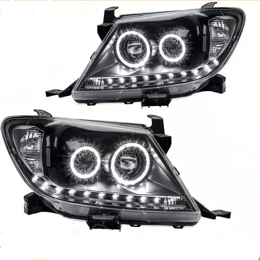 Two car headlights with LED accents on a white background