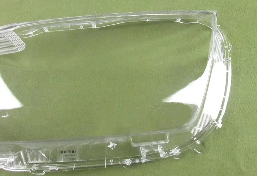 Clear car headlight cover on a green background