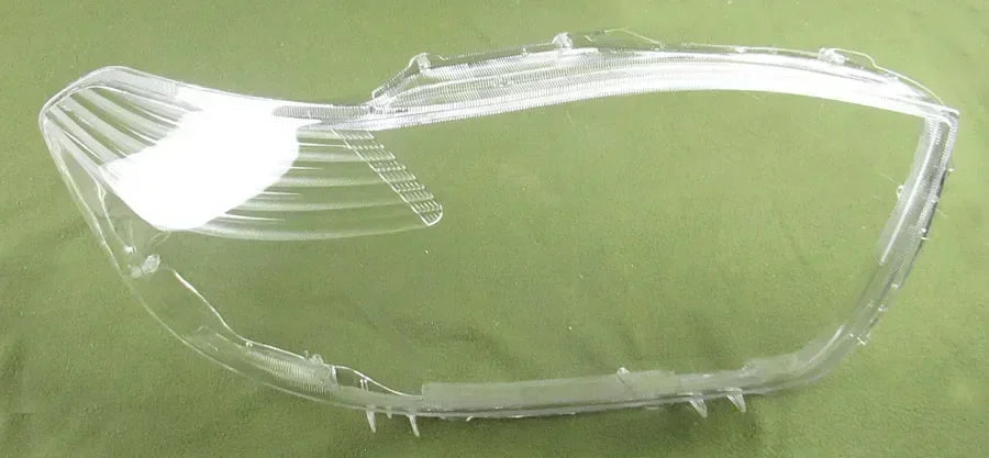Clear car headlight cover on a green background