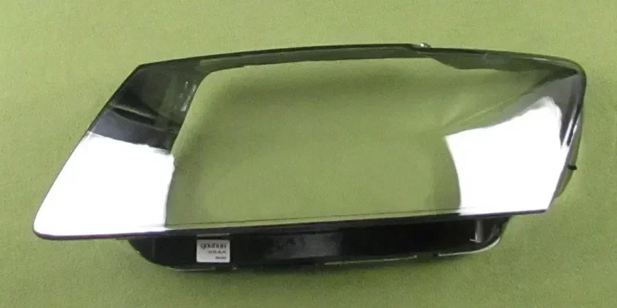 Car headlight cover on a green background