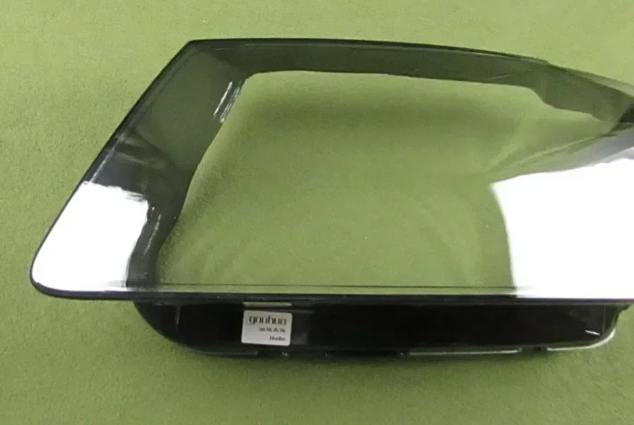 Black rectangular object with a label on a green background