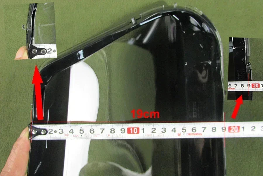 Black car mirror with measurement scale on a green background