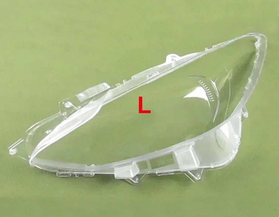 Clear car headlight cover with 'L' marking on a green background