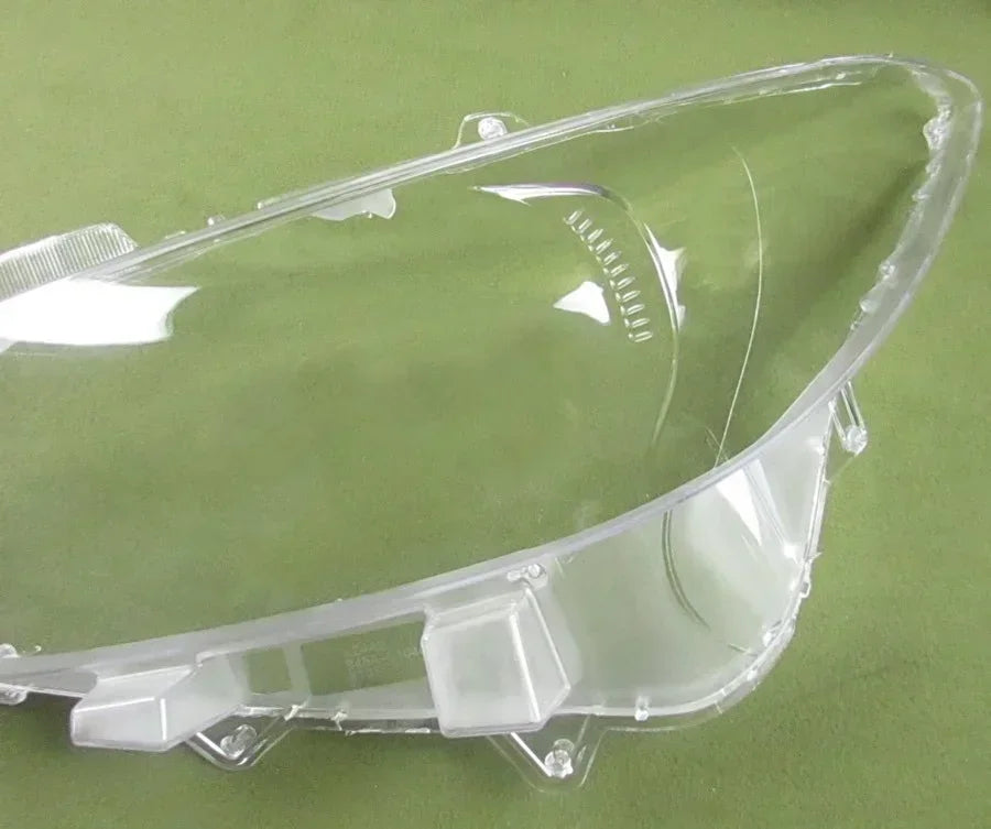 Clear car headlight cover on a green background