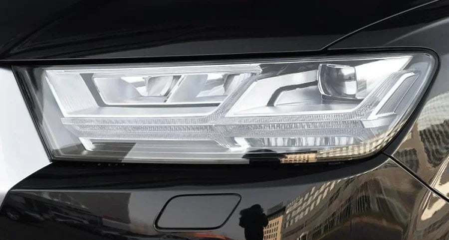 Close-up of a car headlight with a blurred background