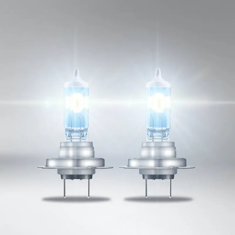 Two halogen car headlights on a gray background