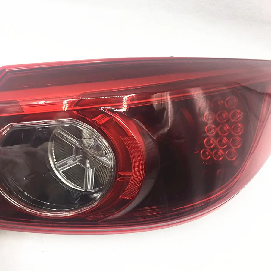 Close-up of a car tail light with red and clear design on a white background