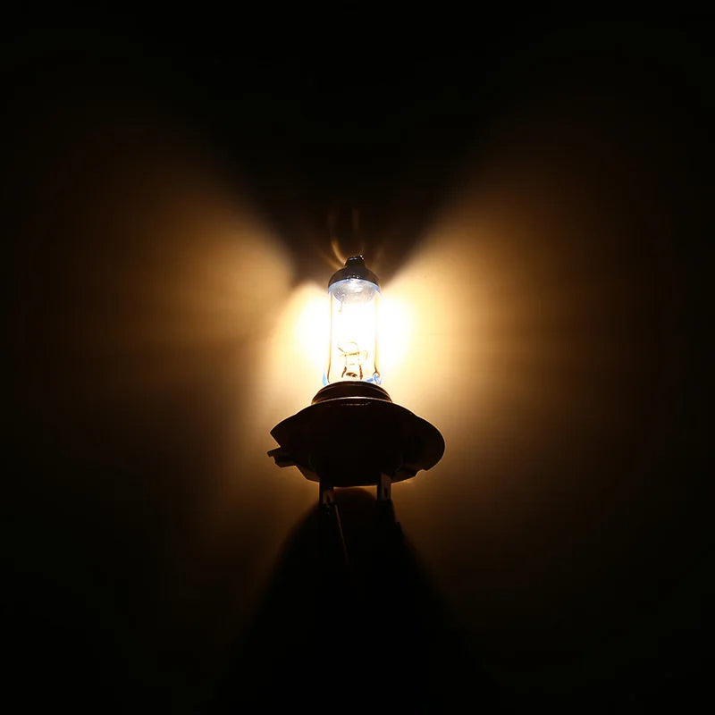 Light bulb emitting a warm glow against a dark background