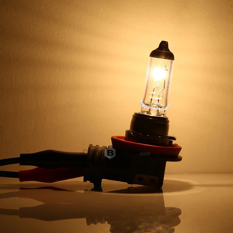 Car headlight bulb with wiring on a reflective surface and beige background