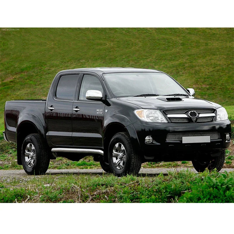 Black Toyota Hilux pickup truck on a grassy background