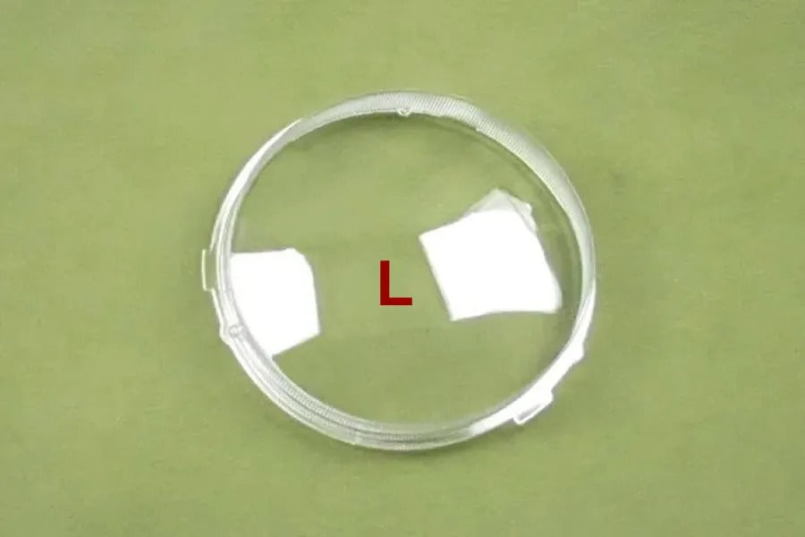 Clear circular object with white squares and a red 'L' on a green background