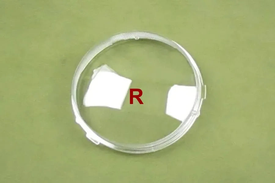 Clear circular object with 'R' marking on a green background