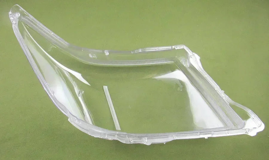 Clear plastic car part on a green background