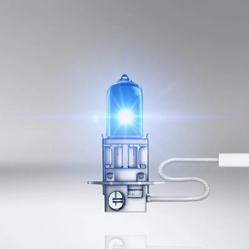 Car headlight bulb with blue light on a gray background