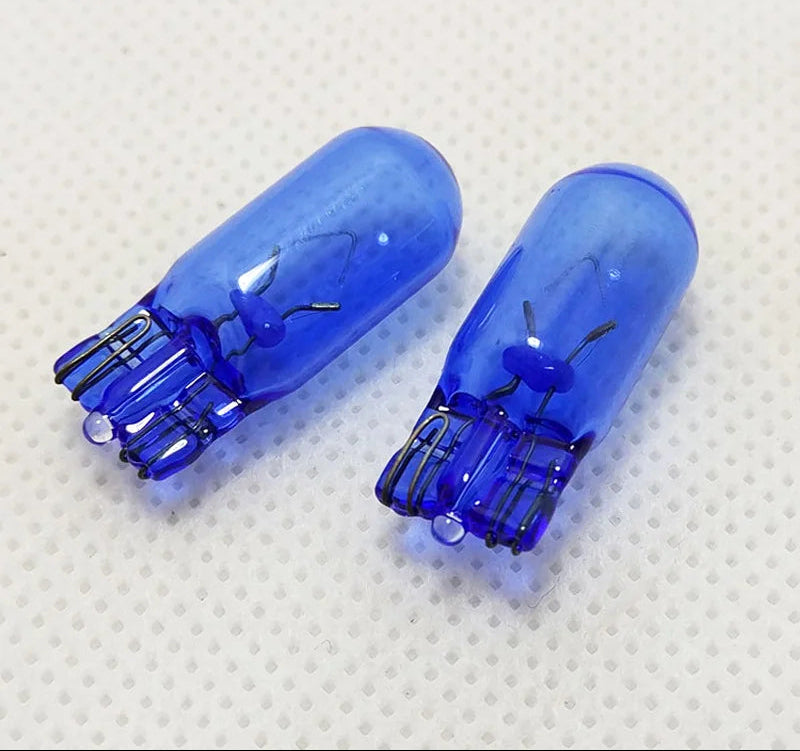 Two blue Philips car lights on a textured white background
